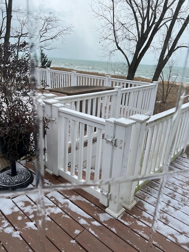 wooden terrace featuring a water view