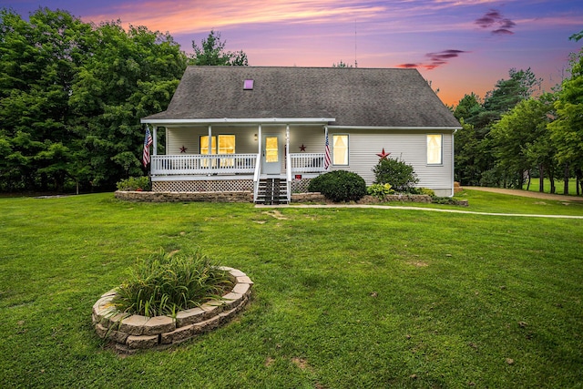 view of front of property with a porch and a yard