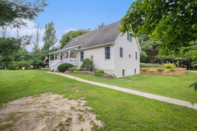 view of front of property featuring covered porch and a front lawn