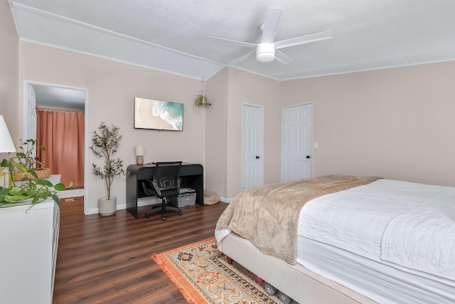 bedroom featuring dark wood-type flooring, ornamental molding, and ceiling fan