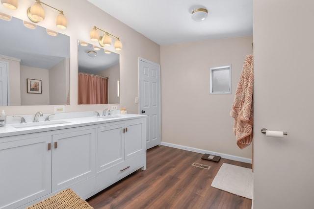 bathroom with vanity and hardwood / wood-style floors