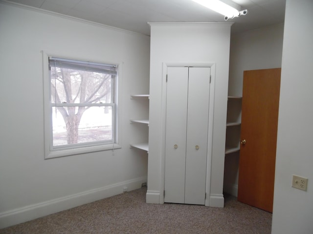 unfurnished bedroom featuring ornamental molding and light colored carpet