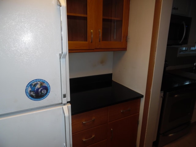 kitchen featuring electric stove and white fridge