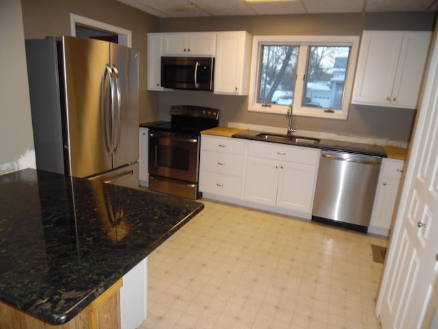 kitchen featuring sink, stainless steel appliances, and white cabinetry