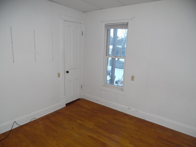 empty room with dark hardwood / wood-style flooring