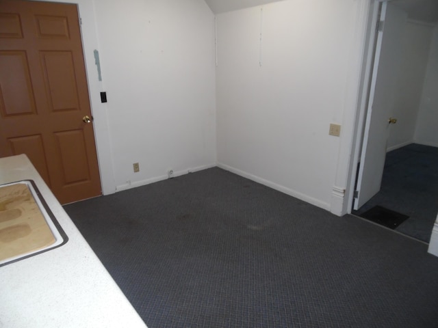 empty room featuring dark colored carpet