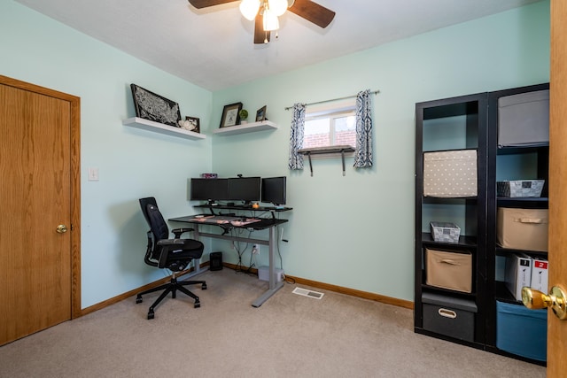 carpeted office space with ceiling fan