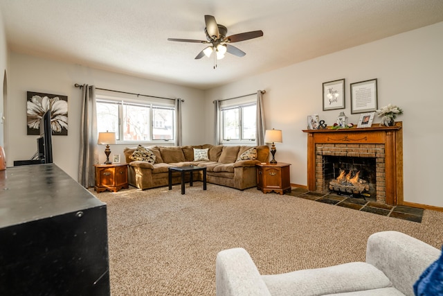 carpeted living room featuring a textured ceiling, ceiling fan, and a brick fireplace