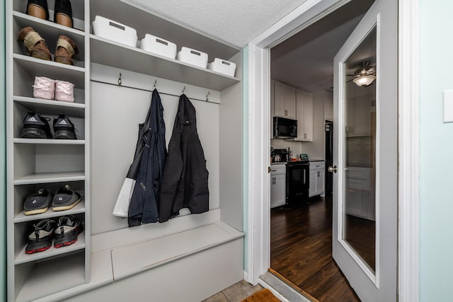 mudroom with a textured ceiling and hardwood / wood-style floors