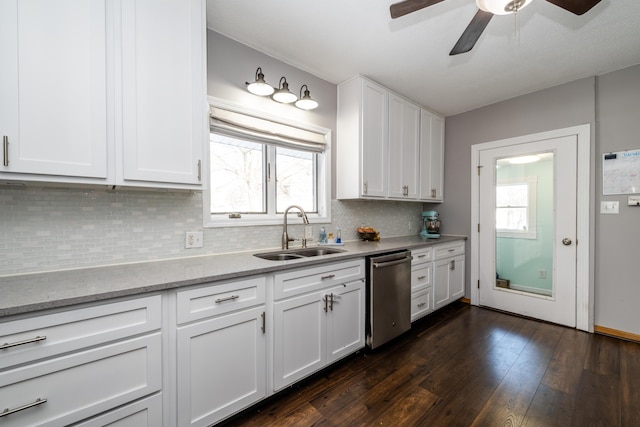 kitchen with white cabinetry, tasteful backsplash, dark hardwood / wood-style flooring, stainless steel dishwasher, and sink