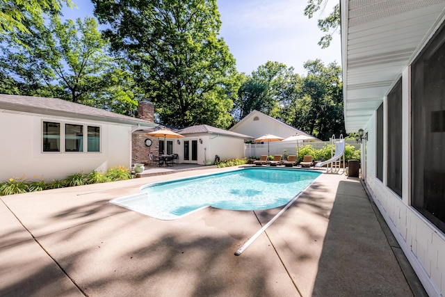 view of swimming pool featuring a water slide and a patio