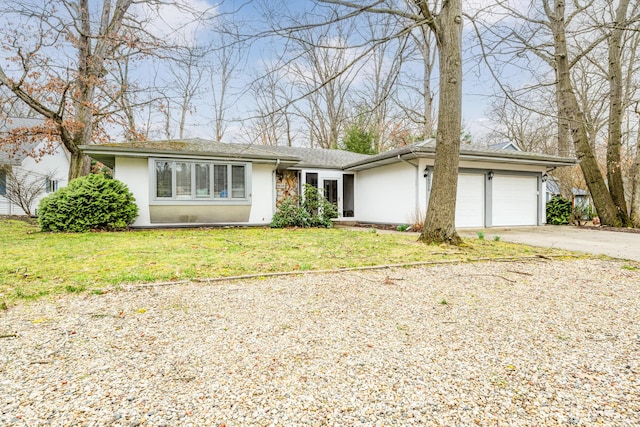 view of front of home with a garage and a front lawn