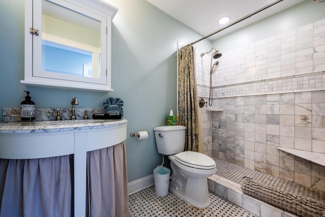 bathroom featuring toilet, curtained shower, tile patterned floors, and vanity