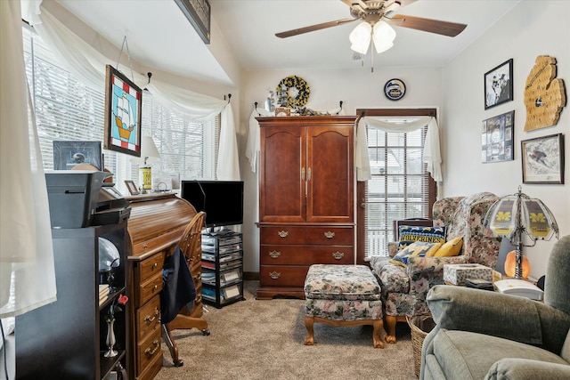 home office featuring ceiling fan and light carpet