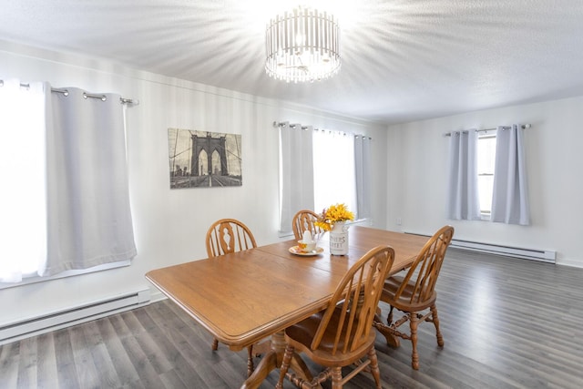 dining area with dark wood-type flooring, a baseboard radiator, a textured ceiling, and a chandelier