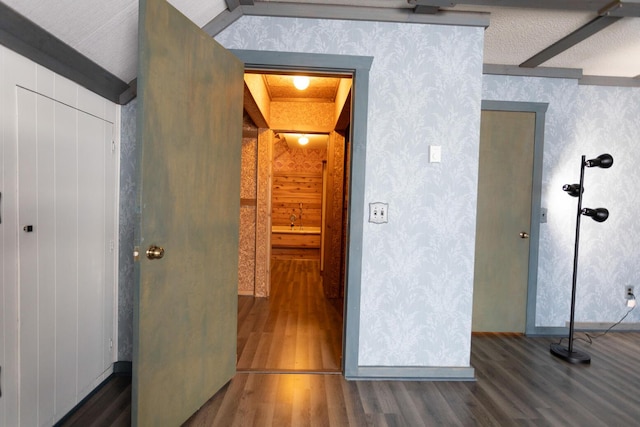 hall featuring beam ceiling and dark wood-type flooring