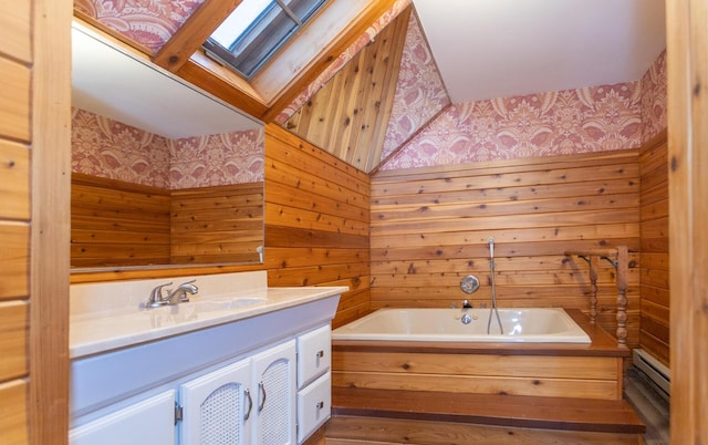 bathroom with a baseboard heating unit, vanity, a skylight, wooden walls, and a washtub