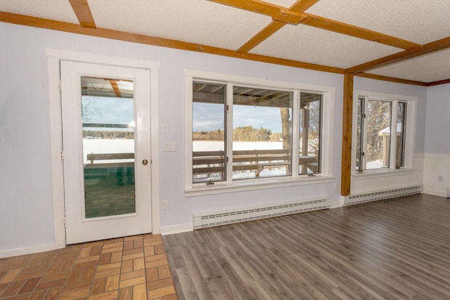 doorway featuring a textured ceiling and a baseboard heating unit