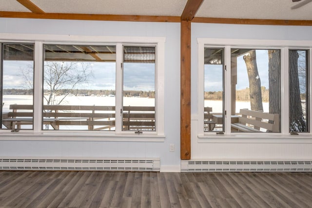 unfurnished sunroom featuring a baseboard heating unit