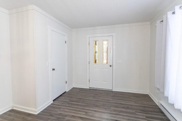 foyer featuring a textured ceiling, dark hardwood / wood-style flooring, and a baseboard radiator