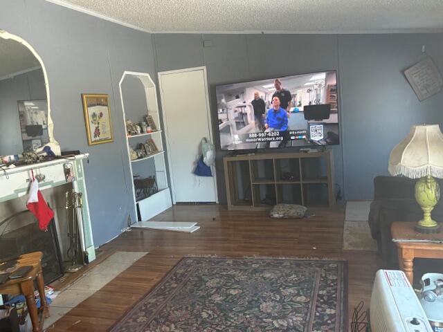 living room with lofted ceiling, dark hardwood / wood-style flooring, a textured ceiling, and built in shelves