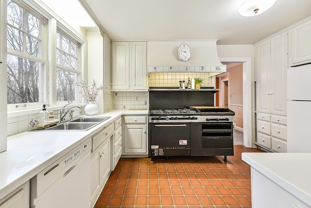 kitchen featuring white cabinetry, sink, and white appliances