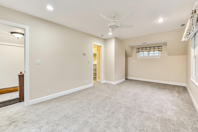 unfurnished room with ceiling fan and carpet