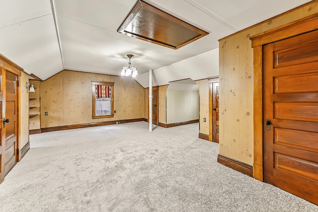 bonus room with carpet floors and vaulted ceiling