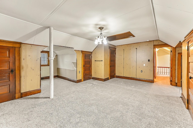 bonus room featuring lofted ceiling and light colored carpet