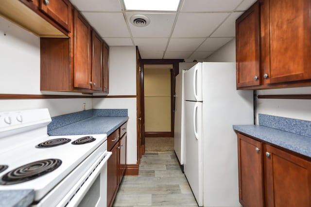 kitchen featuring white appliances, a paneled ceiling, and light wood-type flooring