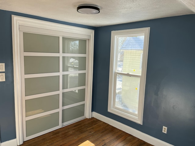 interior details featuring a textured ceiling and hardwood / wood-style flooring