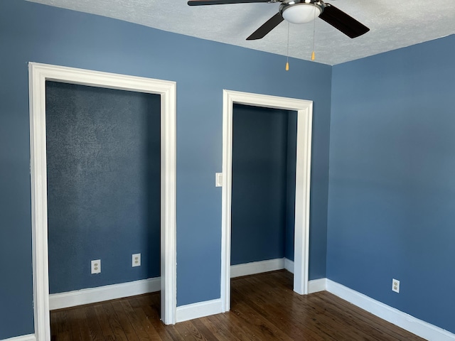 unfurnished bedroom featuring ceiling fan, dark hardwood / wood-style flooring, a closet, and a textured ceiling