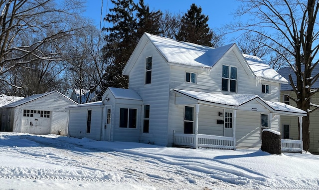 view of front of property featuring covered porch, a garage, and an outdoor structure