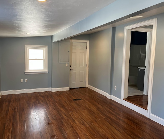 interior space featuring lofted ceiling and dark hardwood / wood-style floors