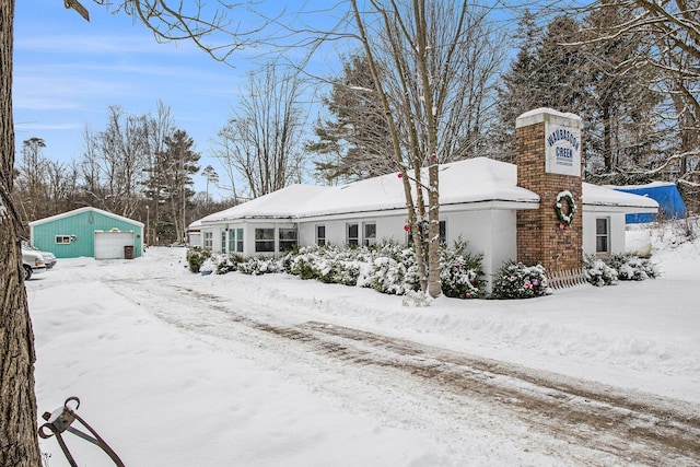 view of front of house with a garage and an outdoor structure