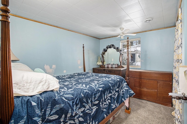 carpeted bedroom with crown molding and ceiling fan