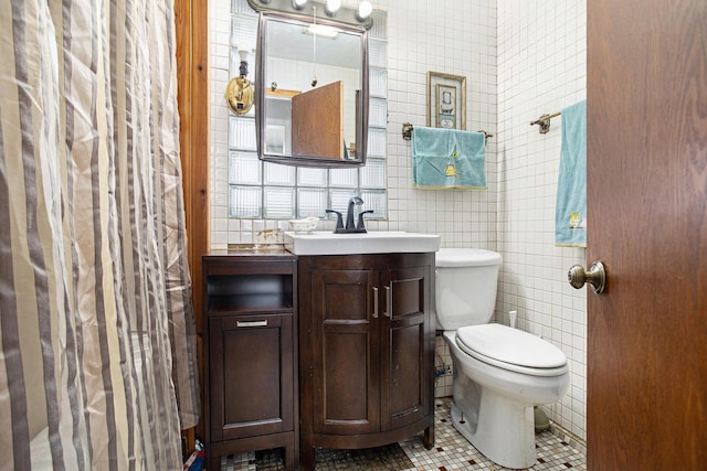 bathroom featuring tile walls, backsplash, vanity, tile patterned floors, and toilet