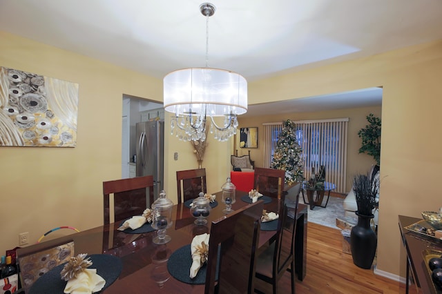 dining room with an inviting chandelier and wood-type flooring