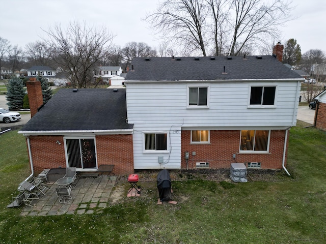 back of property with a patio and a yard