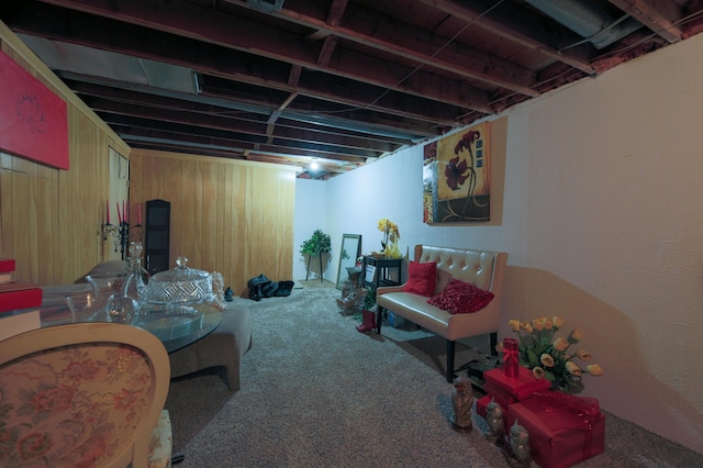 interior space featuring wooden walls and carpet