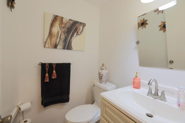 bathroom featuring toilet and vanity