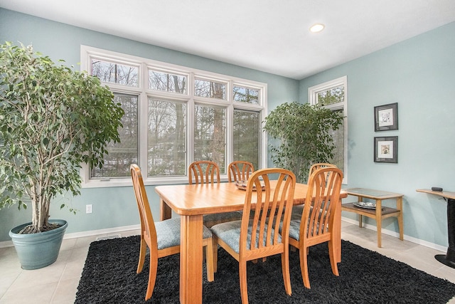 dining room with light tile patterned floors and a wealth of natural light