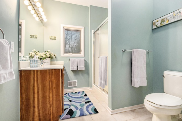 bathroom featuring toilet, tile patterned flooring, an enclosed shower, and vanity