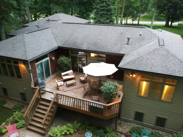 rear view of house featuring a wooden deck