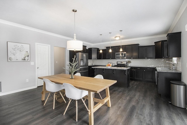 dining room featuring ornamental molding, dark wood-type flooring, and sink