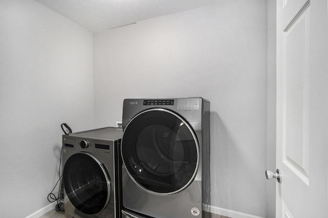 washroom with independent washer and dryer