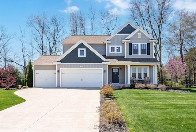 craftsman house featuring a front yard, a garage, and covered porch