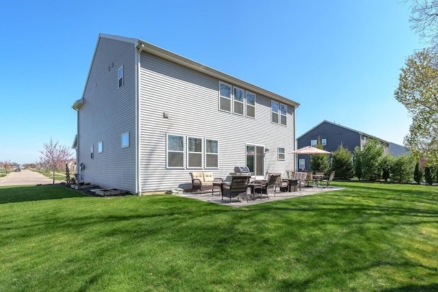 back of house featuring a patio and a yard