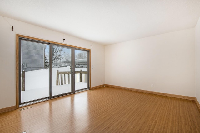 spare room with light hardwood / wood-style flooring