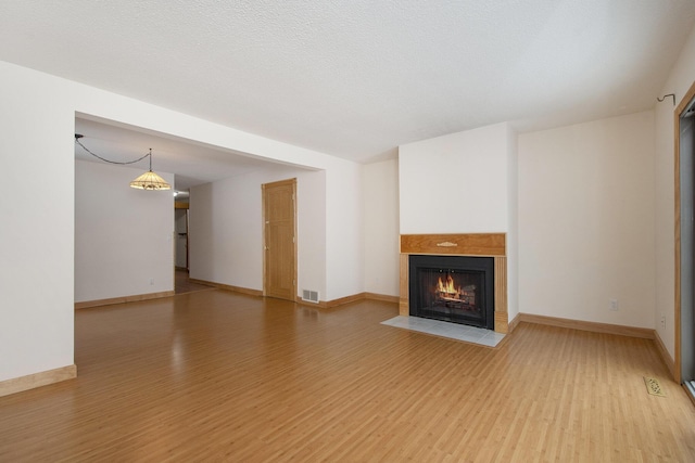 unfurnished living room featuring light hardwood / wood-style floors